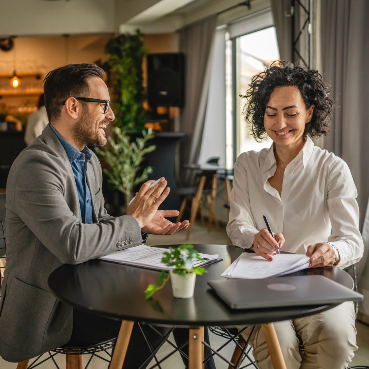 Two professionals reviewing documents together at a table